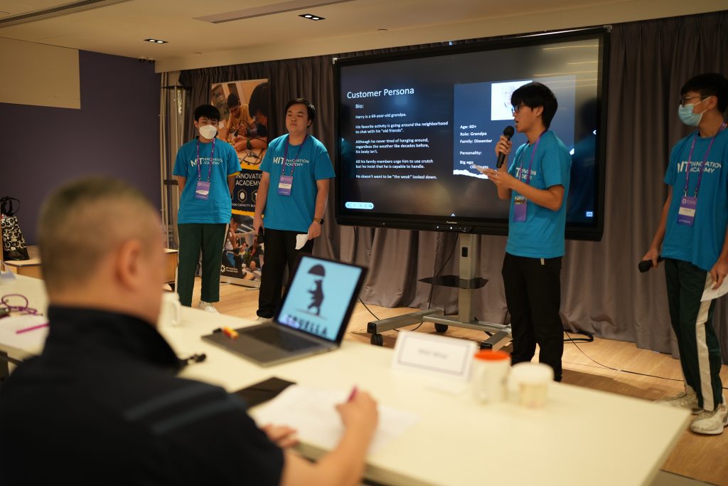 Students pitching their solutions to a panel of judges